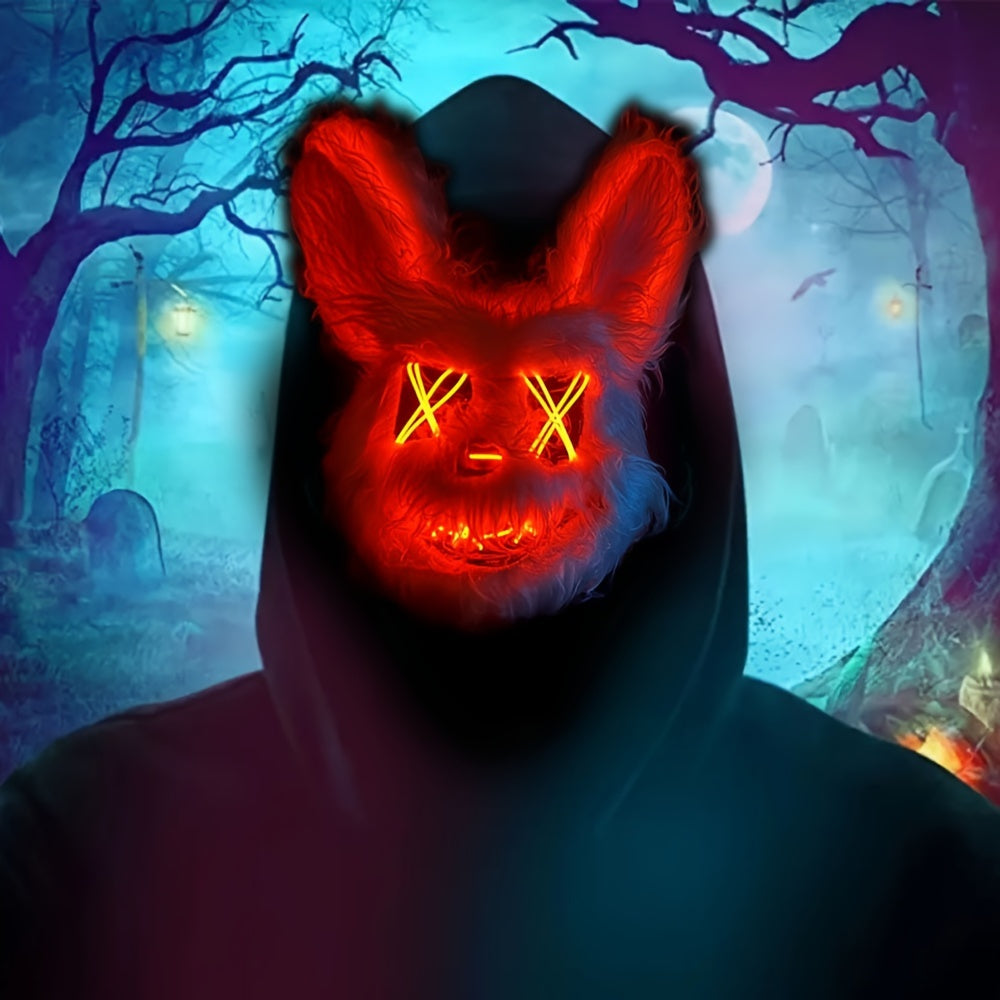 Person wearing a glowing red mask with a dark hood in a spooky forest setting