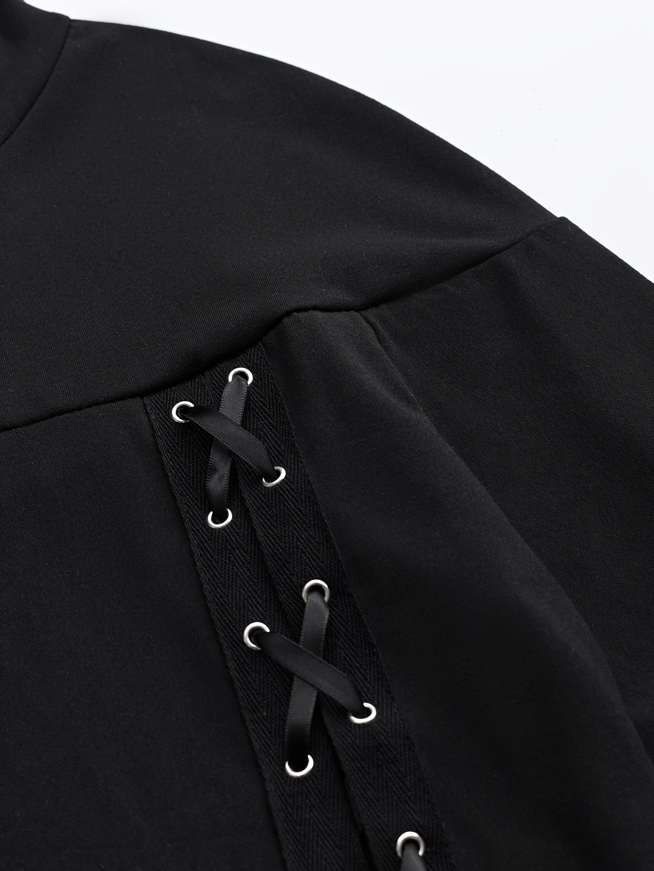 Black garment with lace-up details on a white background