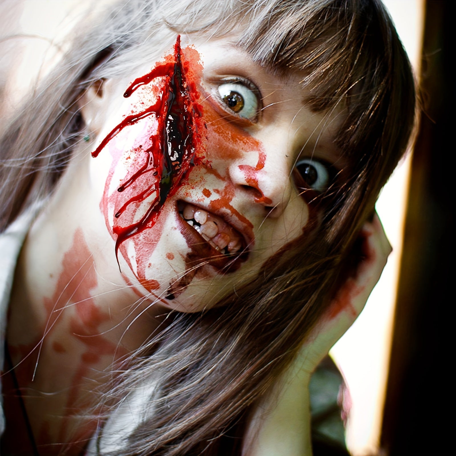 Person with dramatic makeup resembling a zombie or horror character.