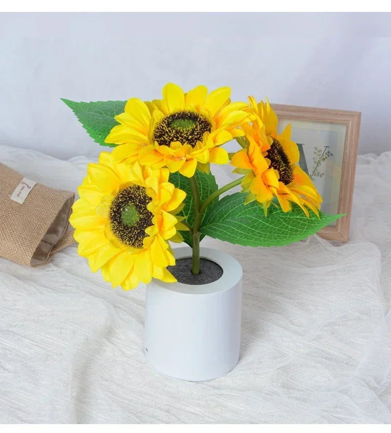 Artificial sunflowers in a white pot on a textured surface with a blurred background