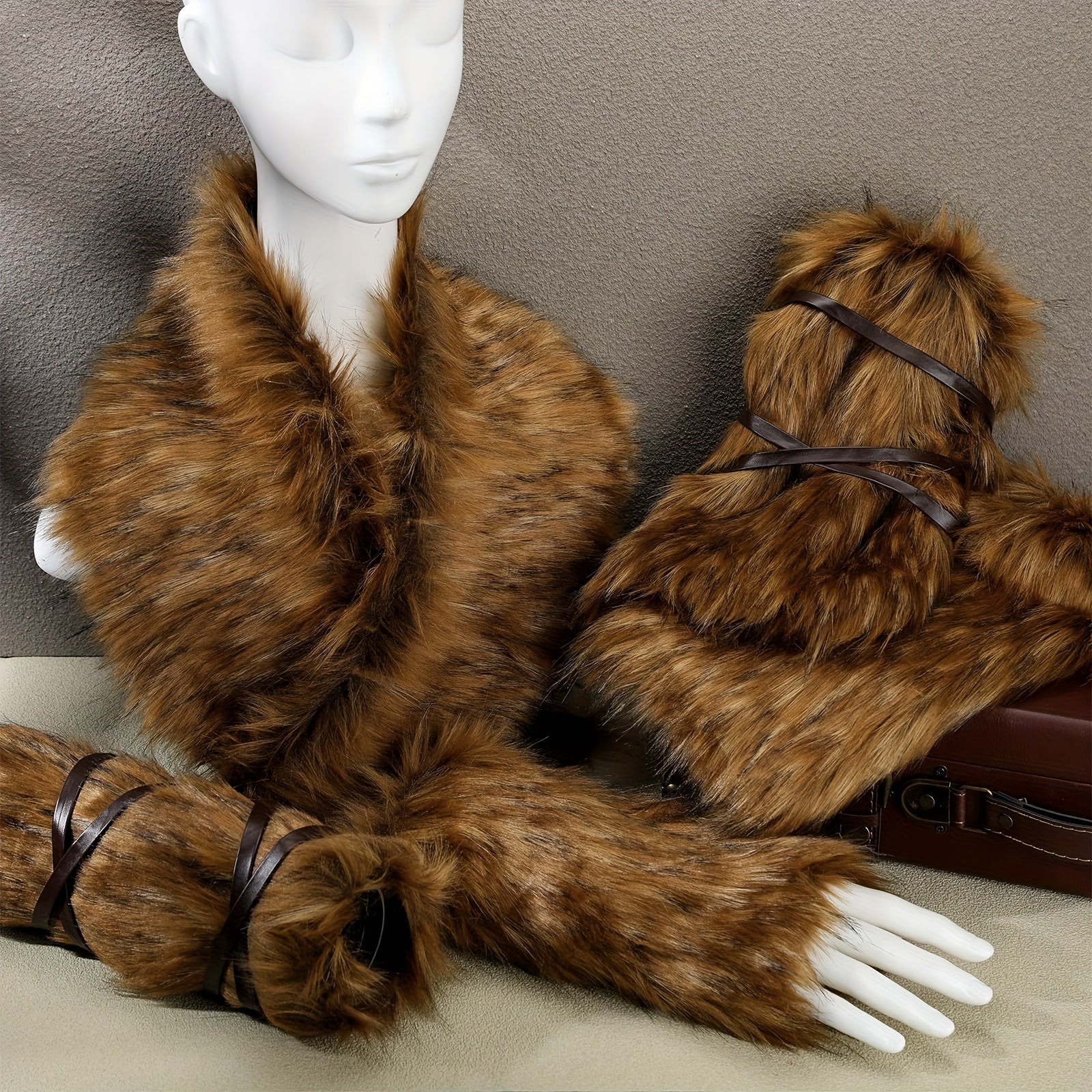 Brown fur coat and gloves on a mannequin against a neutral background