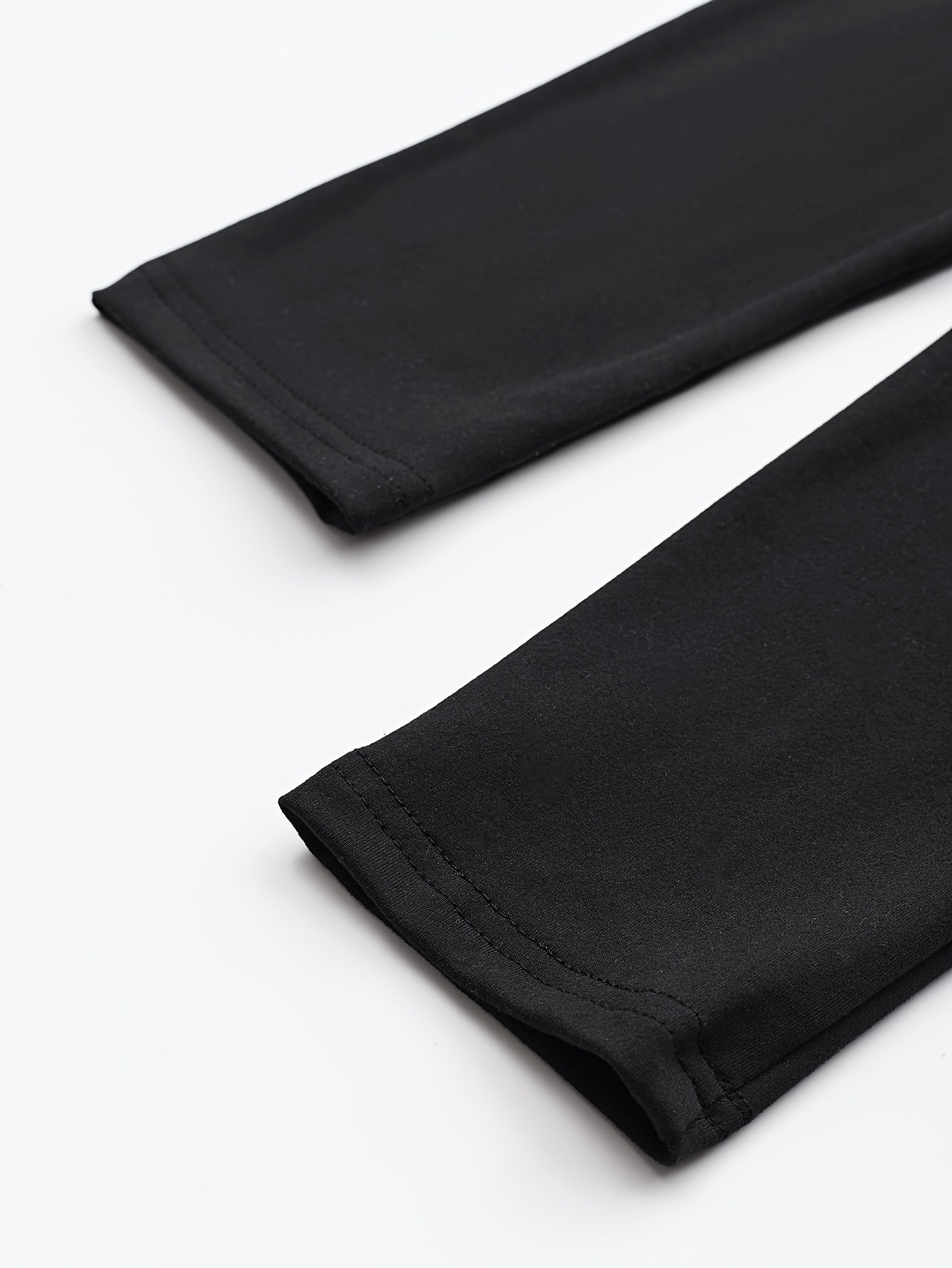 Black leggings folded on a white background