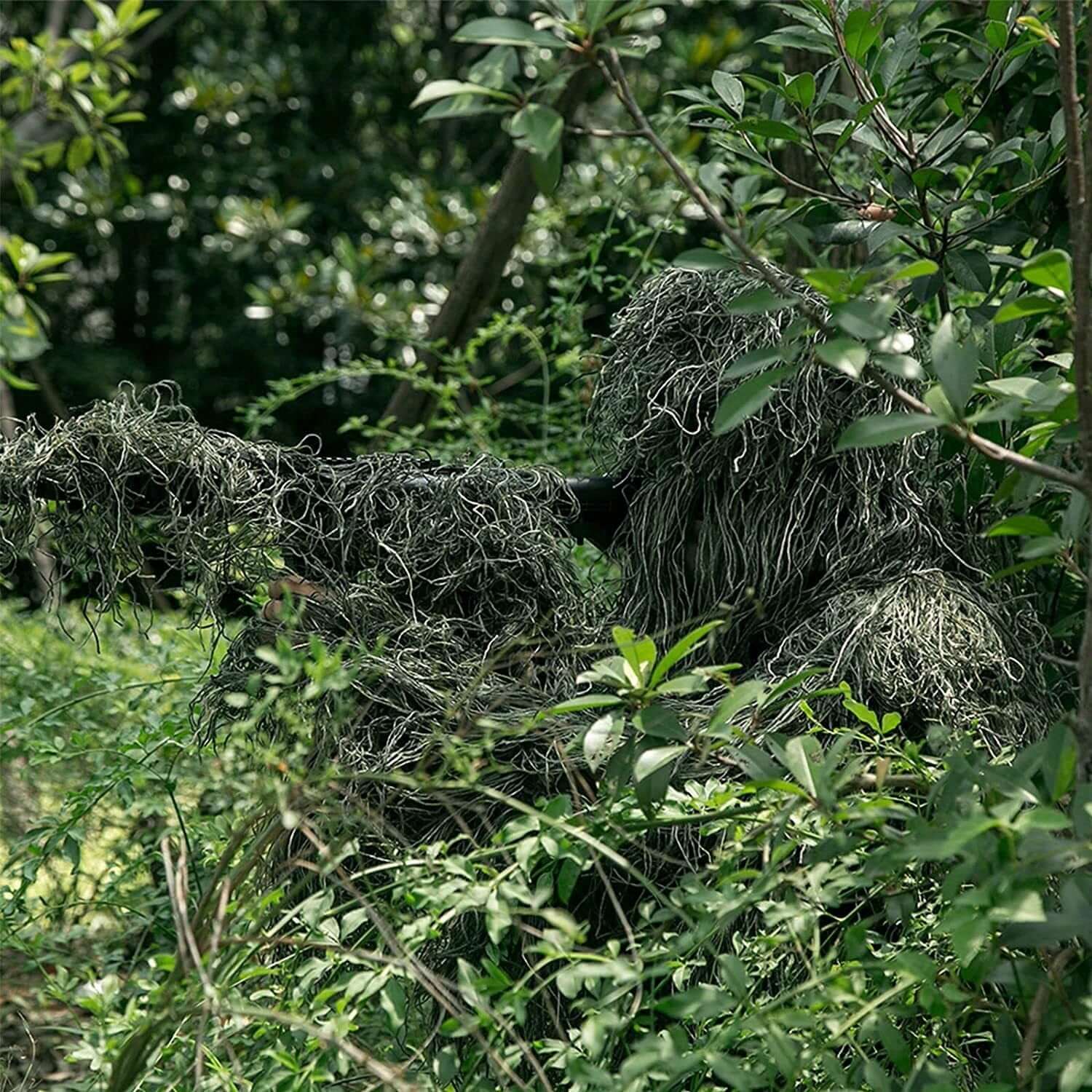 Camouflage netting blending into a natural forest setting